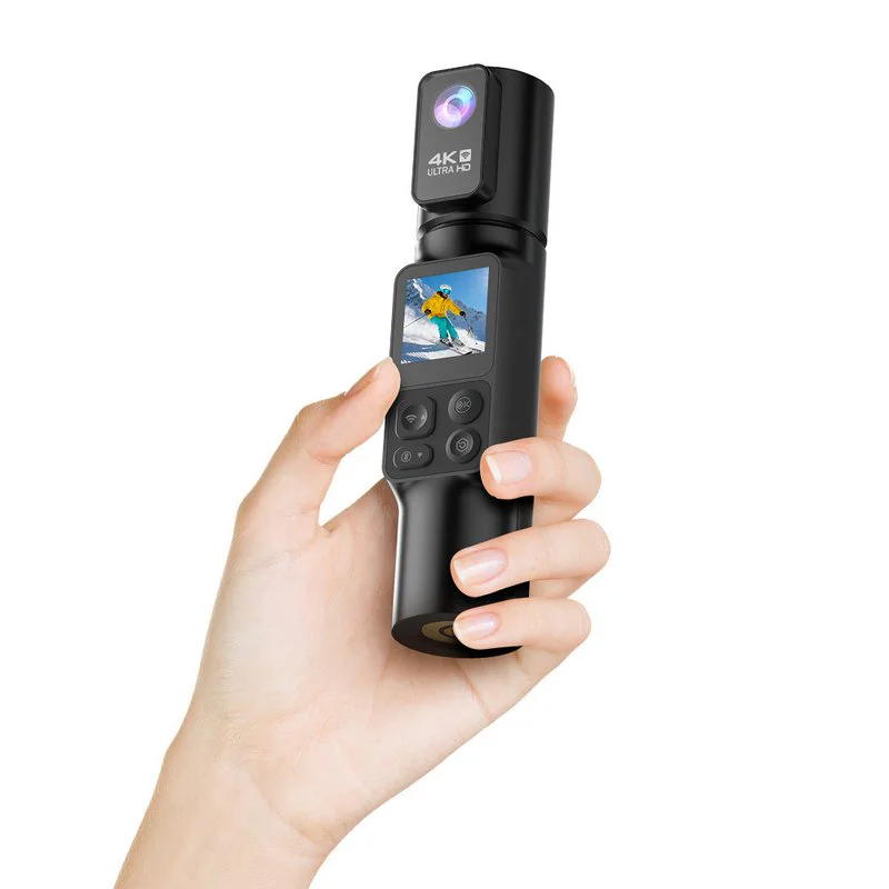 Hand holding black cylindrical pocket camera with active screen