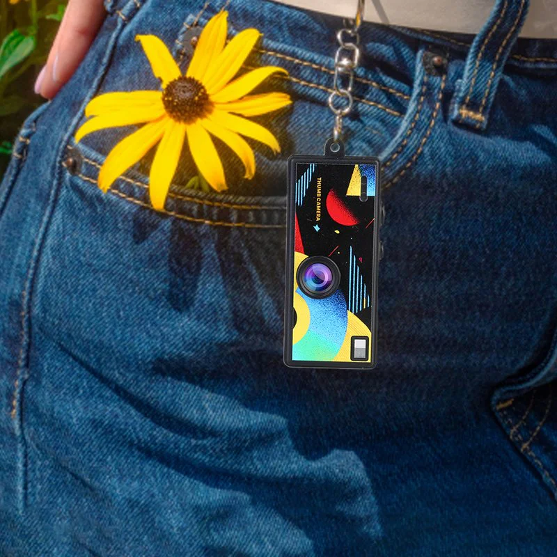 Black AC-G6 keychain camera worn on a belt loop