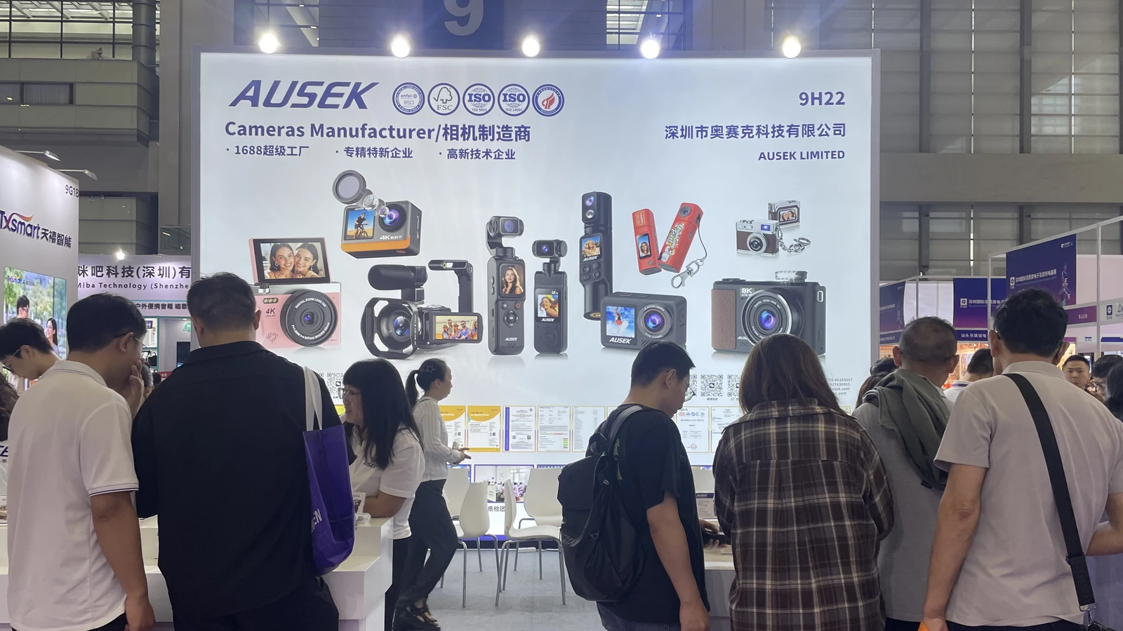 Visitors viewing camera products at a previous AUSEK exhibition booth