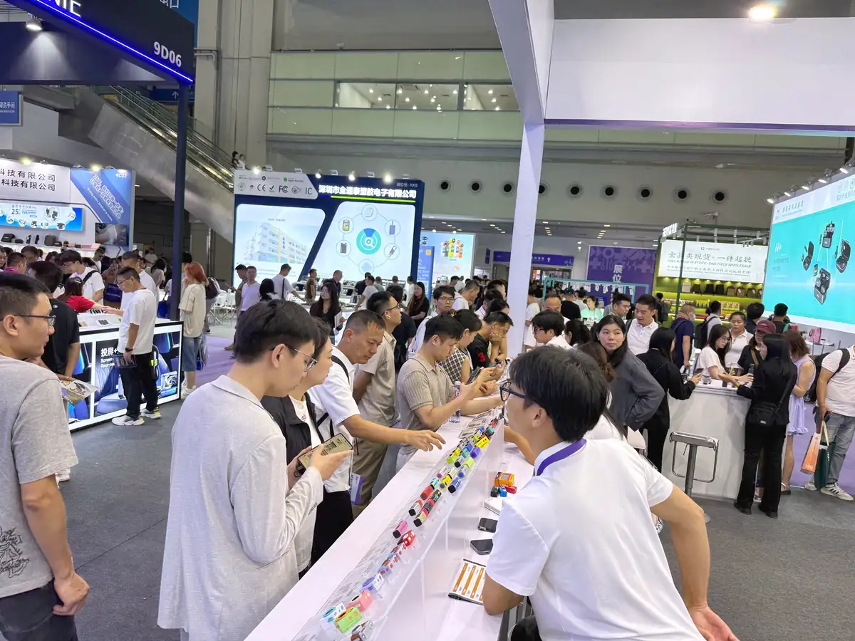 Visitors examining cameras at the AUSEK display counter during IEAE Shenzhen 2026